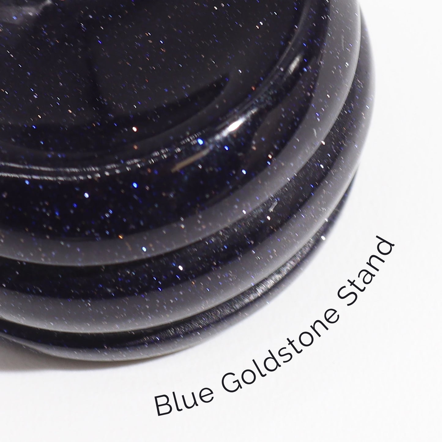 Alt Tag: Red Jasper Mars Gemstone Sphere – 40MM on blue goldstone stand, close-up of glittering base