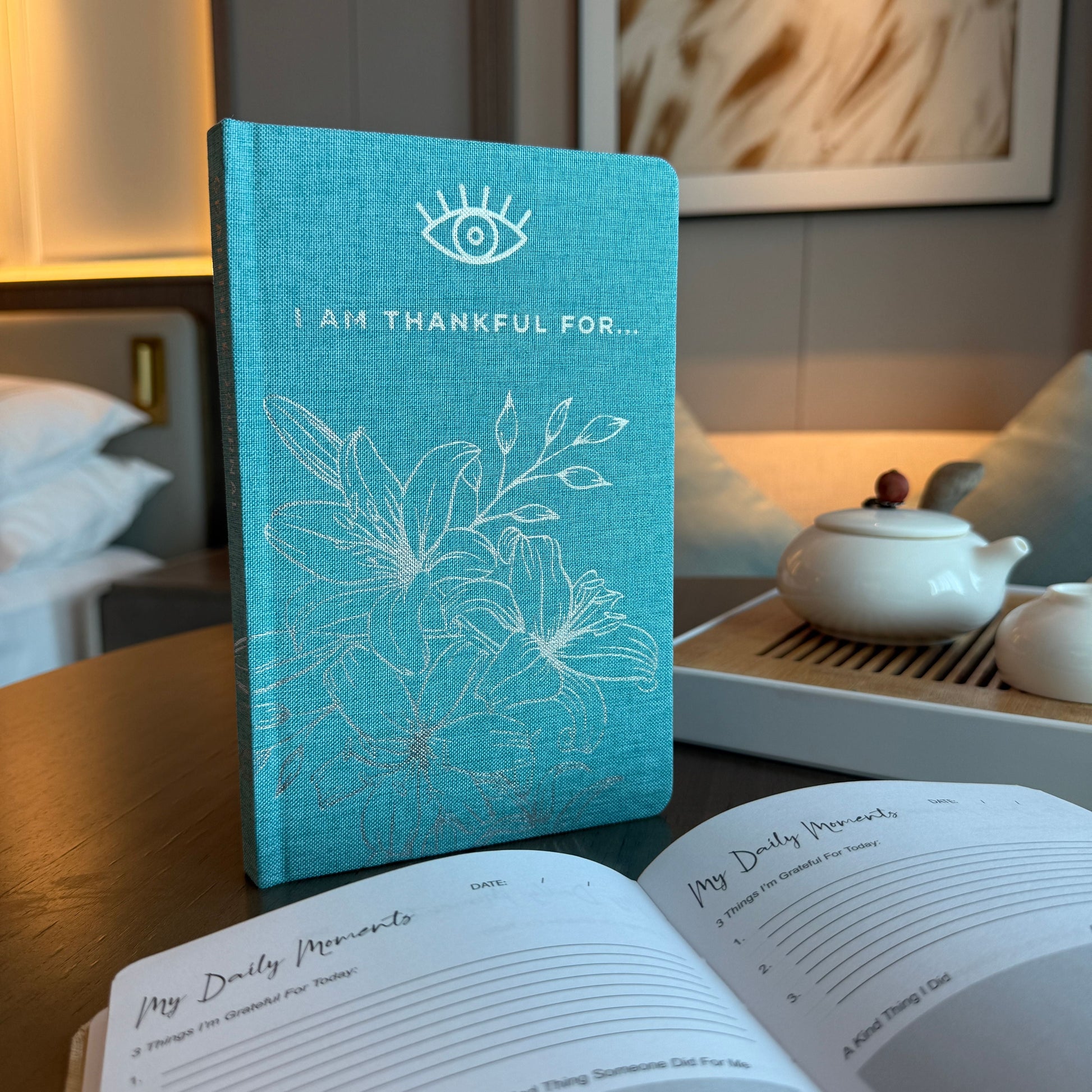 Blue Gratitude Journal with Silver Lining – 120 Pages – I Am Thankful For blue cover journal on desk, "I Am Thankful For" front