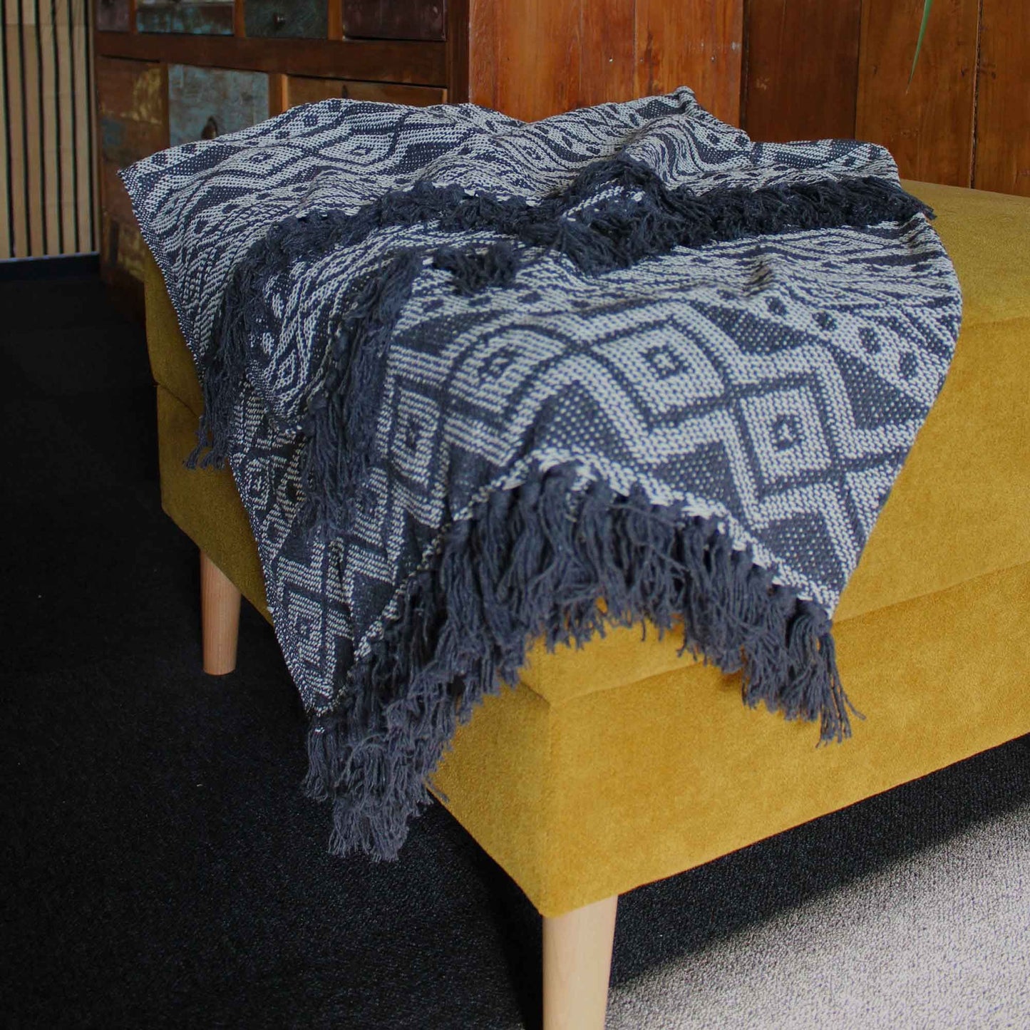 Alt Tag: Boho Comfort Throw – Grey Geometric handwoven cotton throw blanket with grey geometric pattern and fringe, draped on sofa
