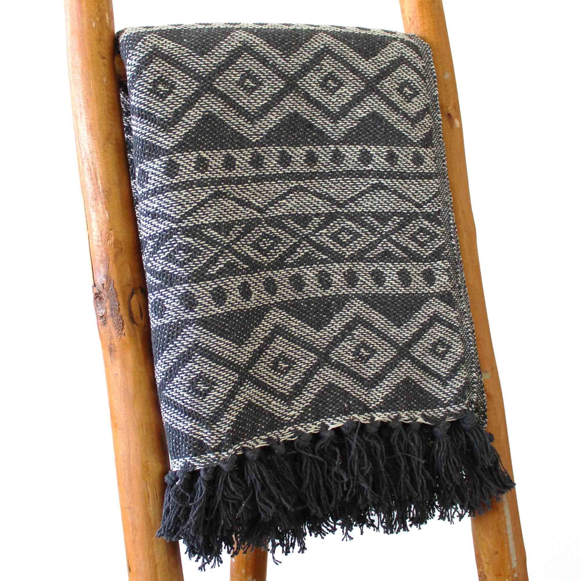 Alt Tag: Boho Comfort Throw – Grey Geometric handwoven cotton throw blanket with grey geometric pattern and fringe on wooden ladder