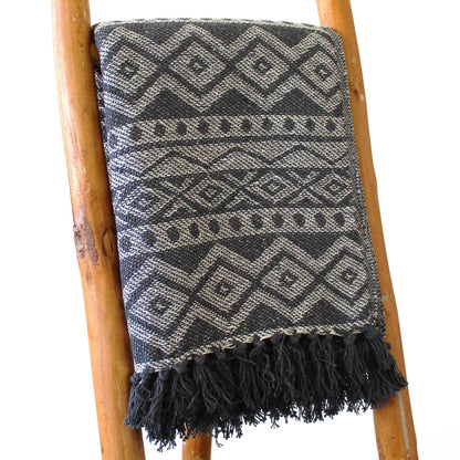 Alt Tag: Boho Comfort Throw – Grey Geometric handwoven cotton throw blanket with grey geometric pattern and fringe on wooden ladder