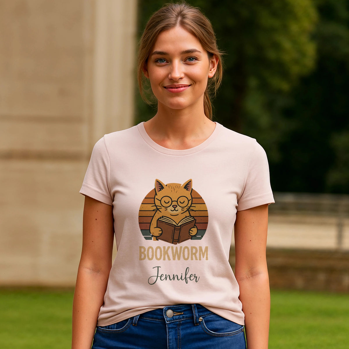 Alt Tag: Bookworm Femenine Personalized Premium Unisex T-Shirt worn by woman, pink tee with bookworm cat graphic and personalized name Jennifer