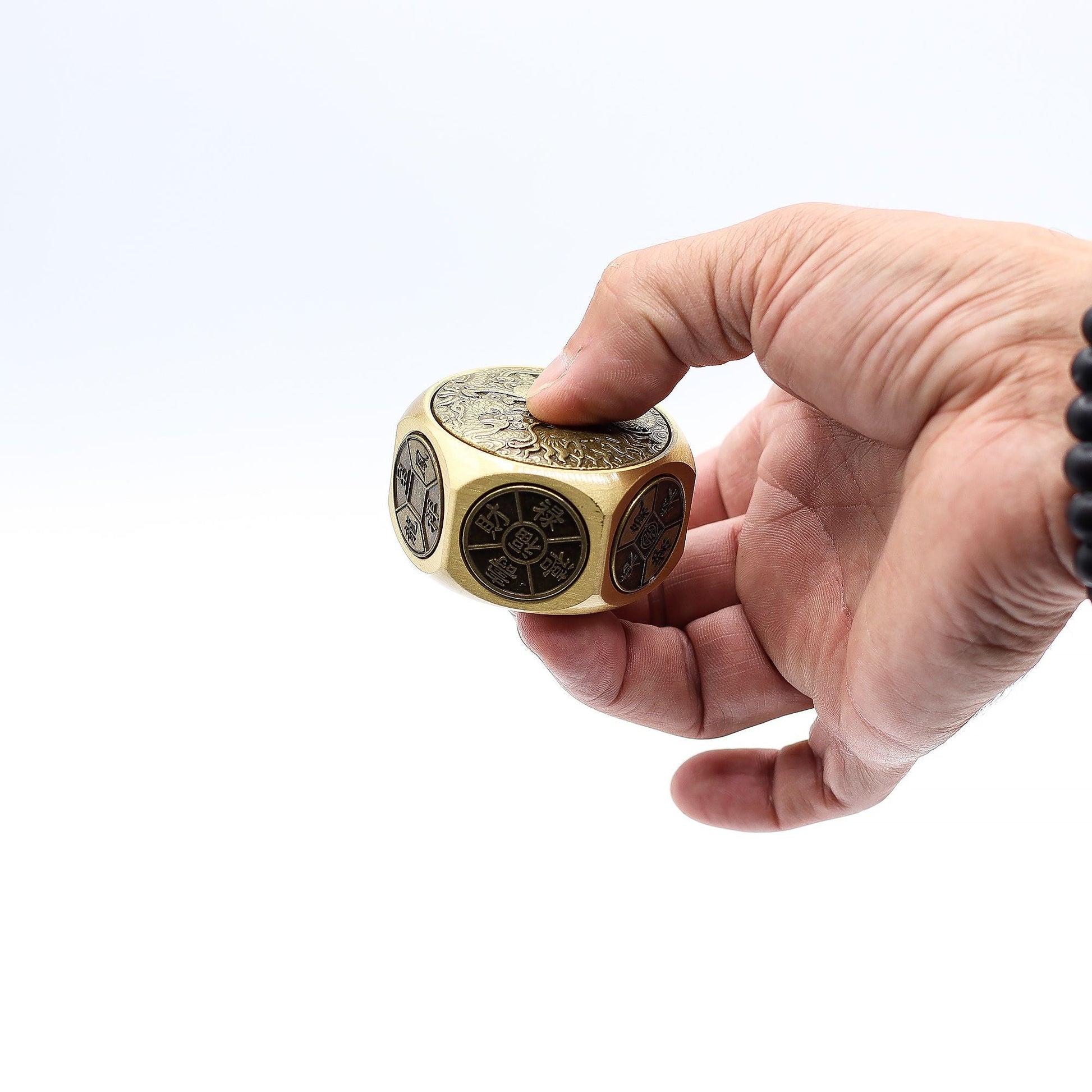 Alt Tag: Hand holding Brass Ancient Fortune Spinner – 5x3.2 CM solid brass dragon-engraved fidget spinner with rounded edges