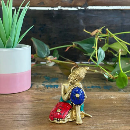 Alt Tag: Brass Buddha Figure – Thinking – 6.5 CM, brass figurine with howlite stones in contemplative pose on wooden table decor