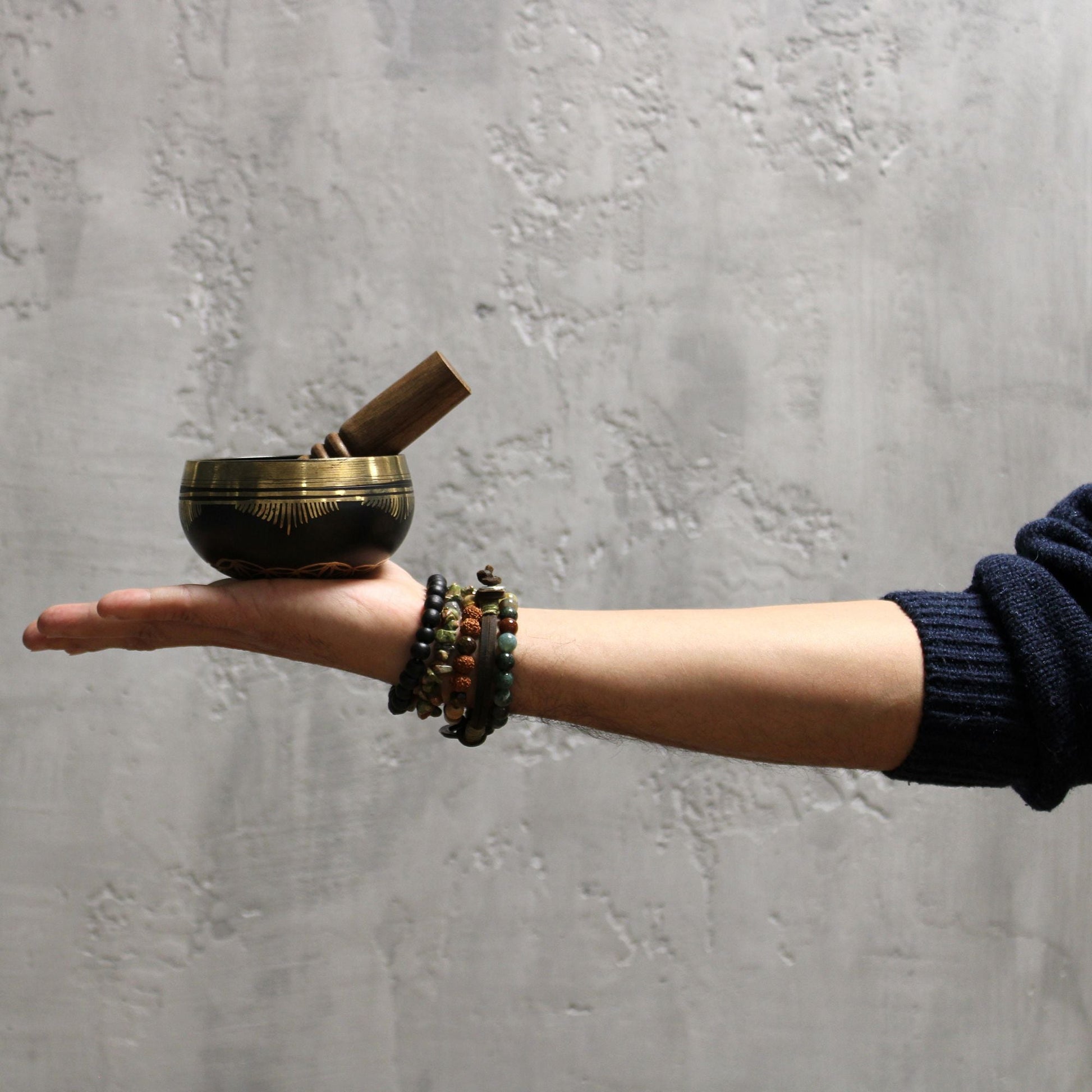 Brass Flower of Life Singing Bowl Set – 9x5 CM on hand with wooden mallet, brass meditation singing bowl close-up