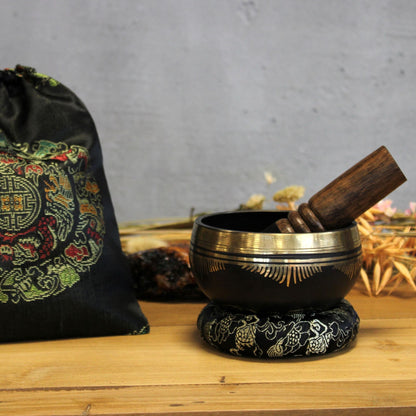 Brass Flower of Life Singing Bowl Set – 9x5 CM with wooden mallet, ring pillow and carrying pouch on wooden surface