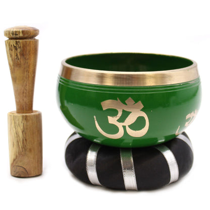 Alt Tag: Brass Tibetan Singing Bowl Set – Green 10.7 CM with wooden striker, green brass bowl with Om symbol on cushion