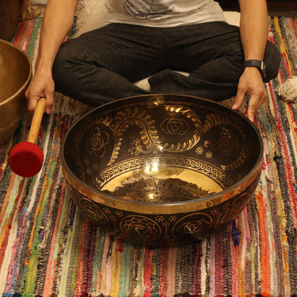 Brass Vibrational Standing Singing Bowl – 50x20CM brass singing bowl with engraved design and mallet on colorful woven rug