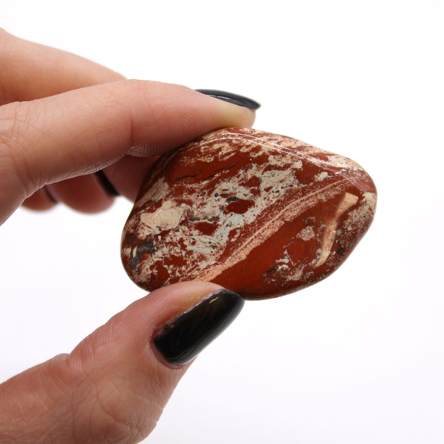 Alt Tag: Brecciated Light Jasper Tumble Stones – Set of 6, close-up of polished beige and tan brecciated jasper stone held in hand