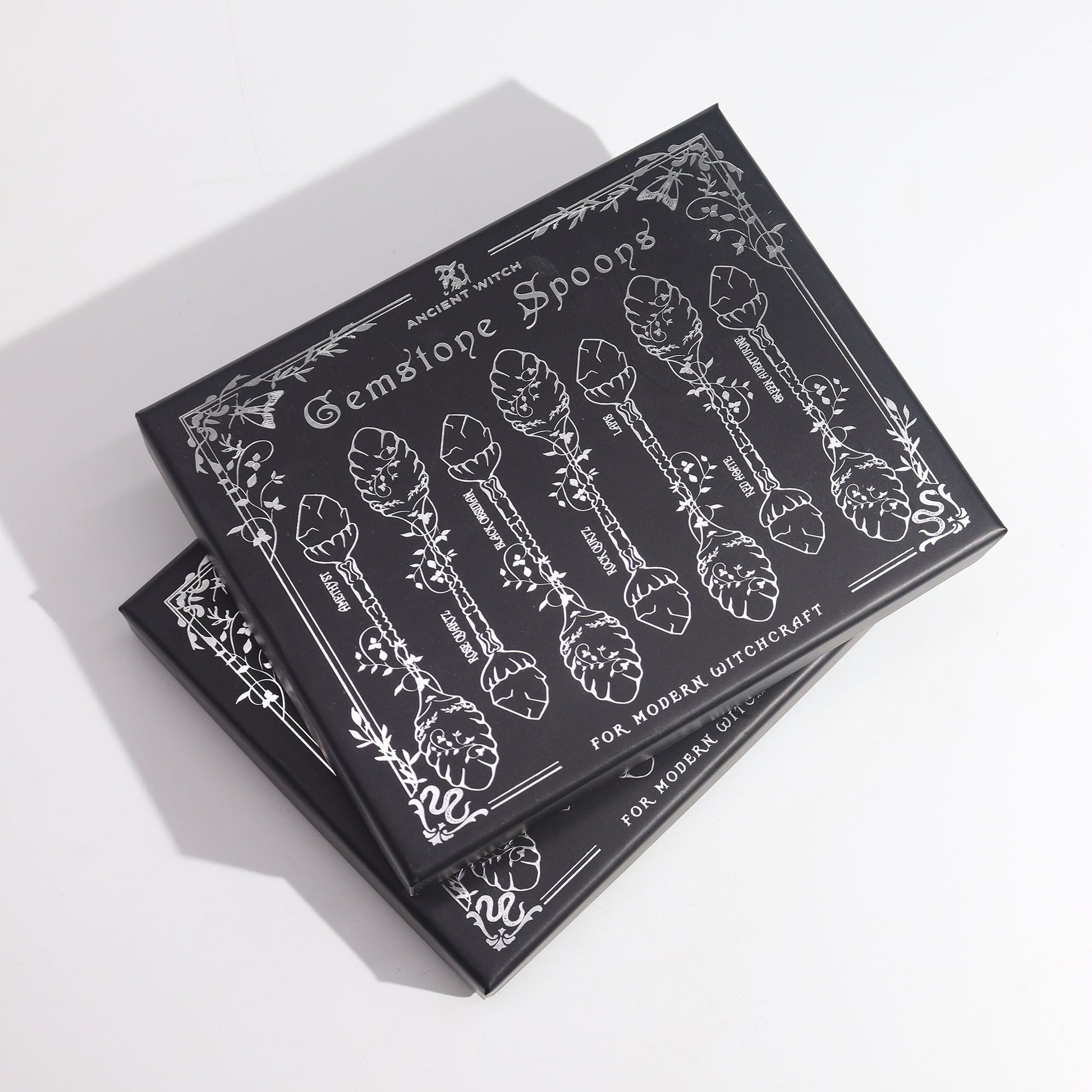 Alt Tag: Bronze Gemstone Witch Spoon Set – 7 Magical Spoons gift box with illustrated spoons and botanical design, black packaging