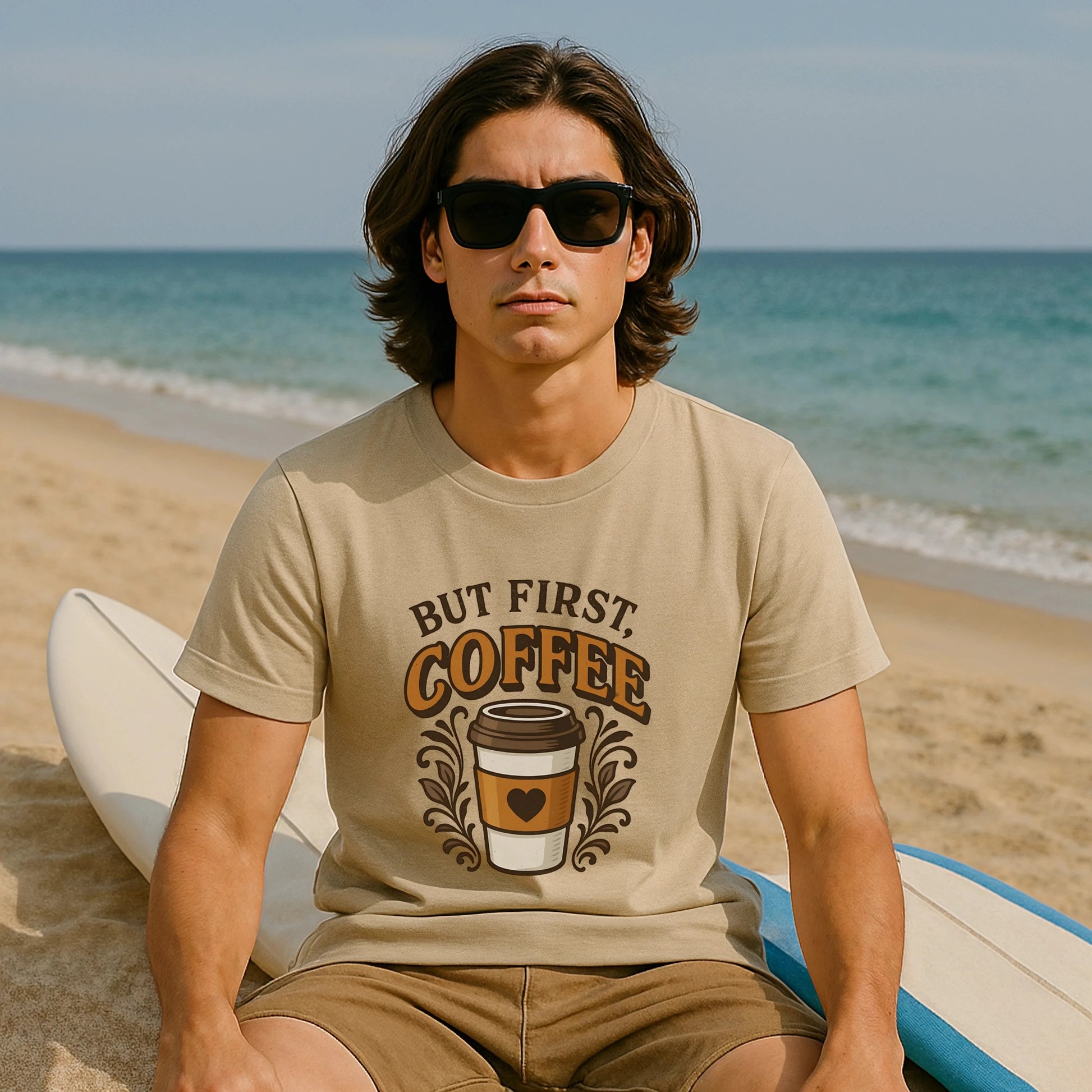 But First Coffee 100% Organic Cotton T-Shirt on model at beach, beige tee with “But First Coffee” graphic and coffee cup design