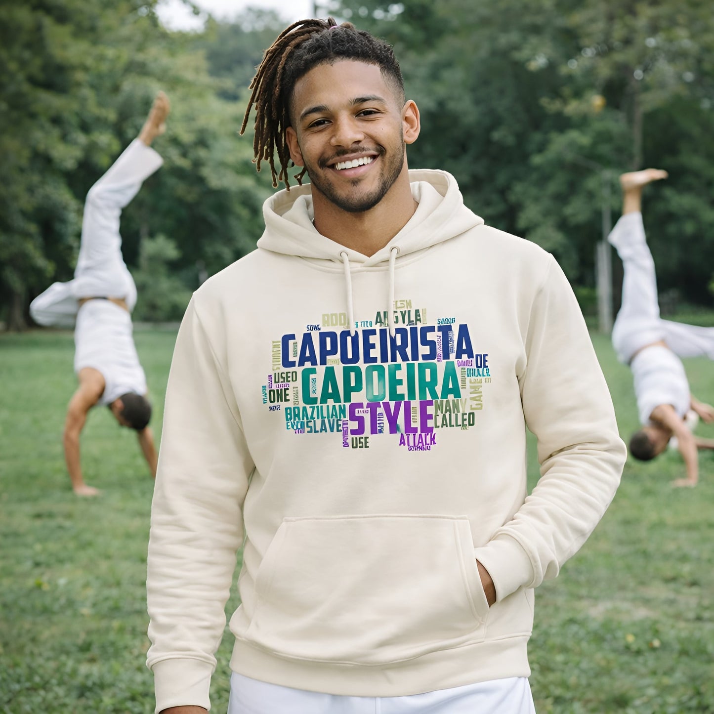 Capoeira Sustainable Unisex Hoodie beige with colorful capoeira typography print, worn by smiling person outdoors in park