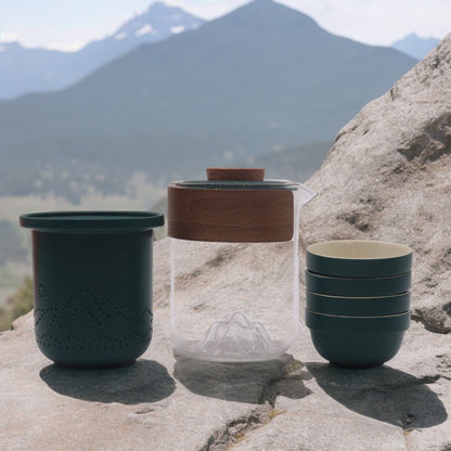 Ceramic Herbal Teapot Set – 300ML with 4 Cups with portable teapot and cups outdoors on rock, travel tea set with case
