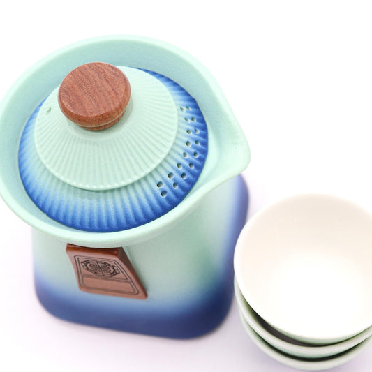Alt Tag: Ceramic Herbal Teapot Set – Blue Heaven Edition ceramic teapot with strainer lid and matching tea cups, blue gradient finish