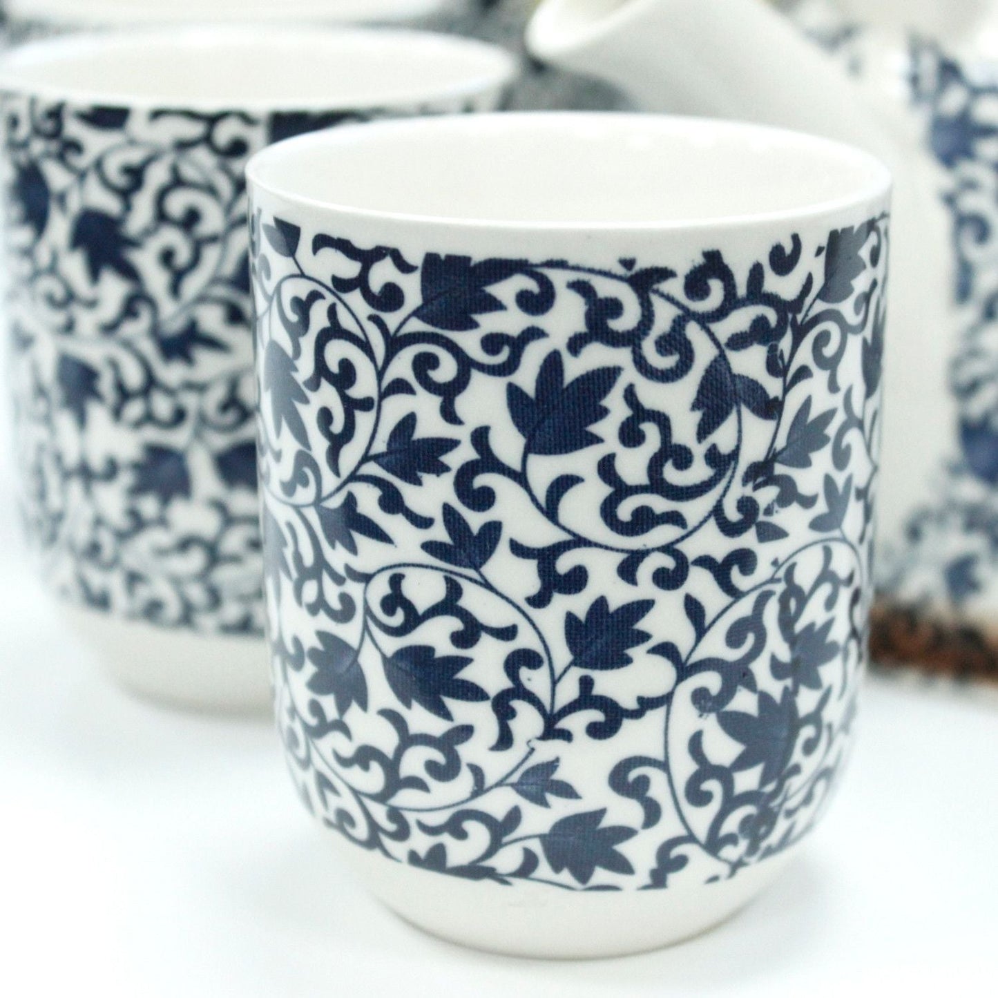 Alt Tag: Ceramic Herbal Teapot Set – Blue Pattern, 6 Cups ceramic cup with intricate blue floral pattern, close-up