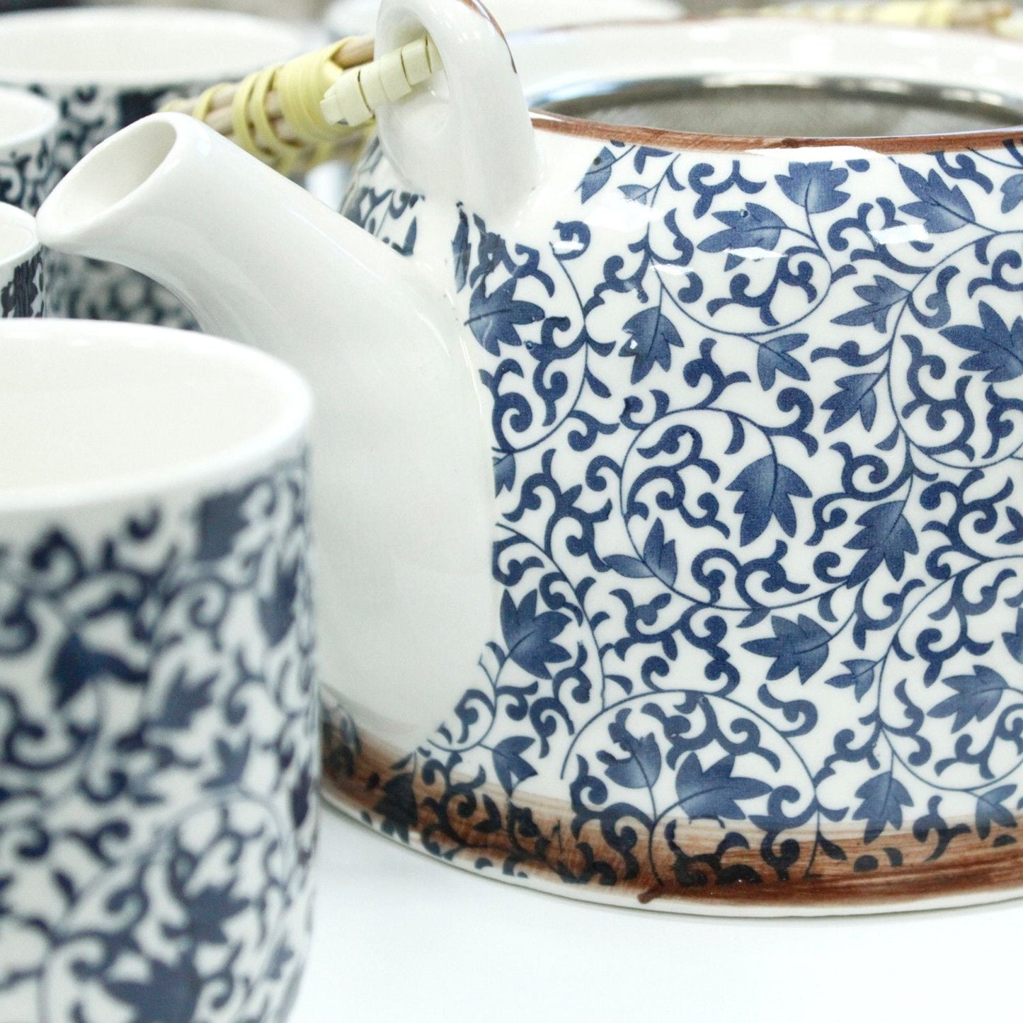 Alt Tag: Ceramic Herbal Teapot Set – Blue Pattern, 6 Cups, close-up of ceramic teapot spout and matching cup with blue floral pattern