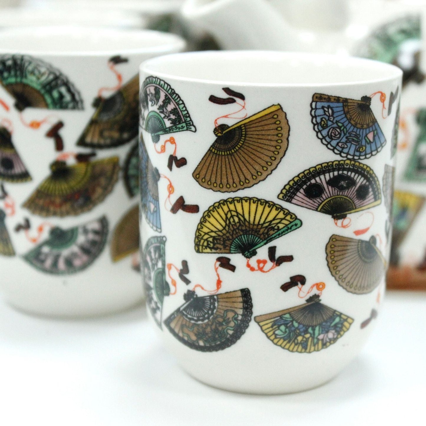 Ceramic Herbal Teapot Set – China Fans Design matching ceramic teacups with colorful fan pattern, close-up