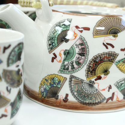 Alt Tag: Ceramic Herbal Teapot Set – China Fans Design ceramic teapot close-up with colorful fan pattern, spout and matching cup