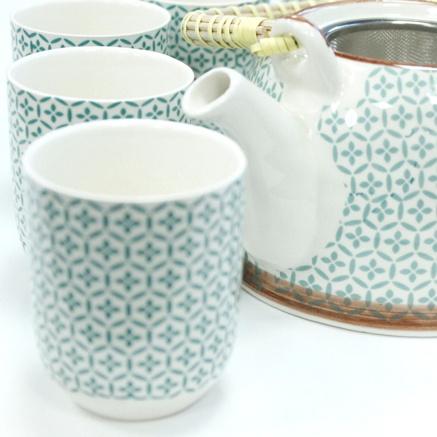 Ceramic Herbal Teapot Set – Green Mosaic with 6 Cups with metal strainer, white ceramic teapot and patterned cups close-up