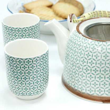 Ceramic Herbal Teapot Set – Green Mosaic with 6 Cups, ceramic teapot with metal strainer and matching cups on table