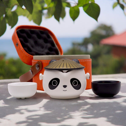 Alt Tag: Ceramic Herbal Teapot Set – 2 Cups & Travel Case with panda ceramic teapot, two cups and orange travel case outdoors