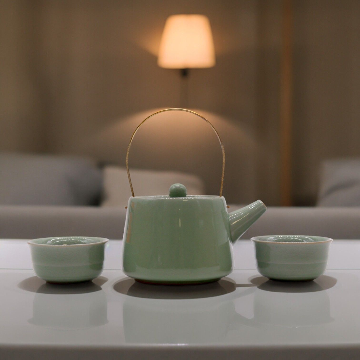Alt Tag: Ceramic Jade Teapot Set – 11x9x8 CM jade green ceramic teapot with gold-toned handle and two matching cups on table