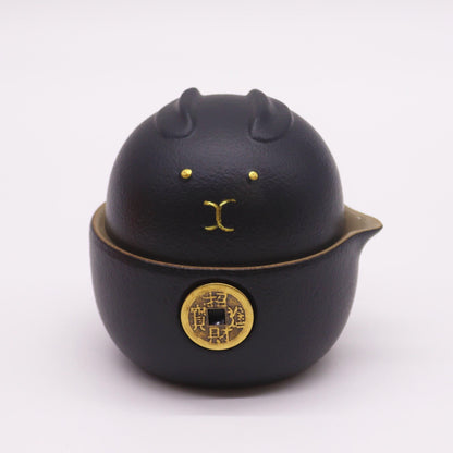 Alt Tag: Ceramic Money Cat Teapot Set – 2 Cups Black black ceramic money cat teapot with gold coin motif and lid, front view