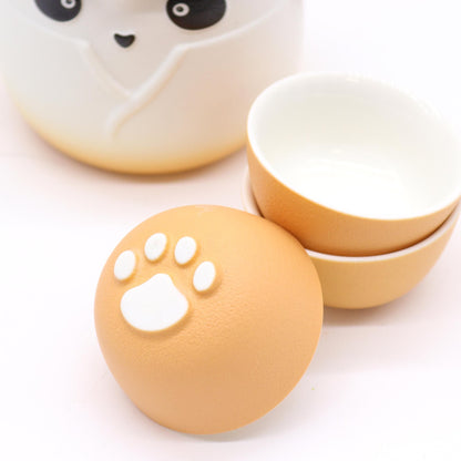 Alt Tag: Ceramic Panda Teapot Set – Orange with panda teapot, orange ceramic cups and paw-print lid detail