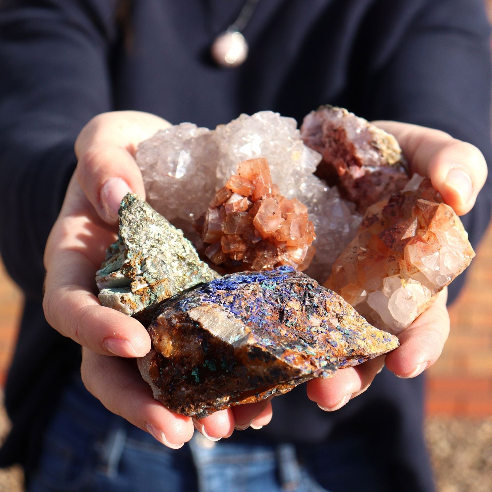 Alt Tag: Chalcopyrite Mineral Collection – Approx. 80 Pieces held in hands, mixed crystal and mineral specimens with metallic chalcopyrite and quartz clusters