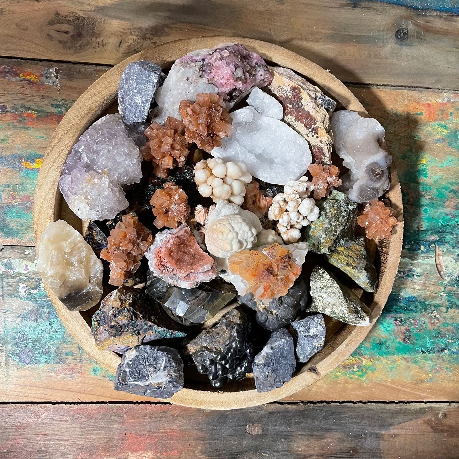 Alt Tag: Chalcopyrite Mineral Collection – Approx. 80 Pieces, assorted mineral specimens in wooden bowl on rustic tabletop