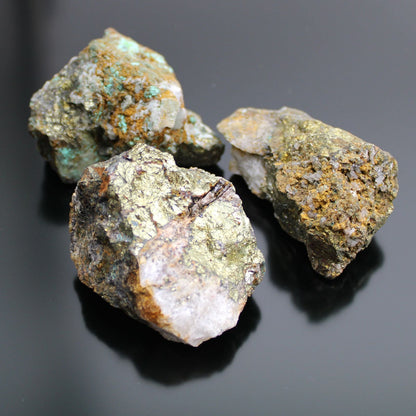 Alt Tag: Chalcopyrite Mineral Collection – Approx. 80 Pieces, raw chalcopyrite mineral specimens with metallic gold luster on black background