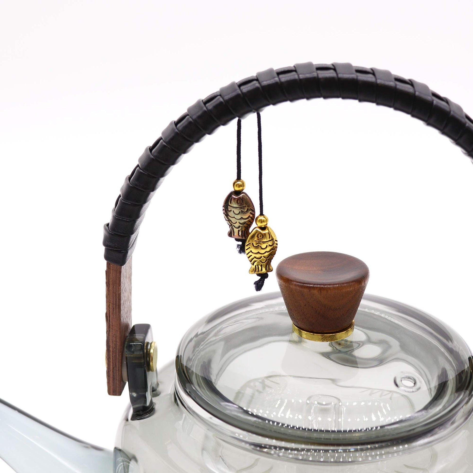 Charcoal Glass Infuser Teapot – 1000ML close-up of glass lid with wooden knob, curved handle and hanging fish charms