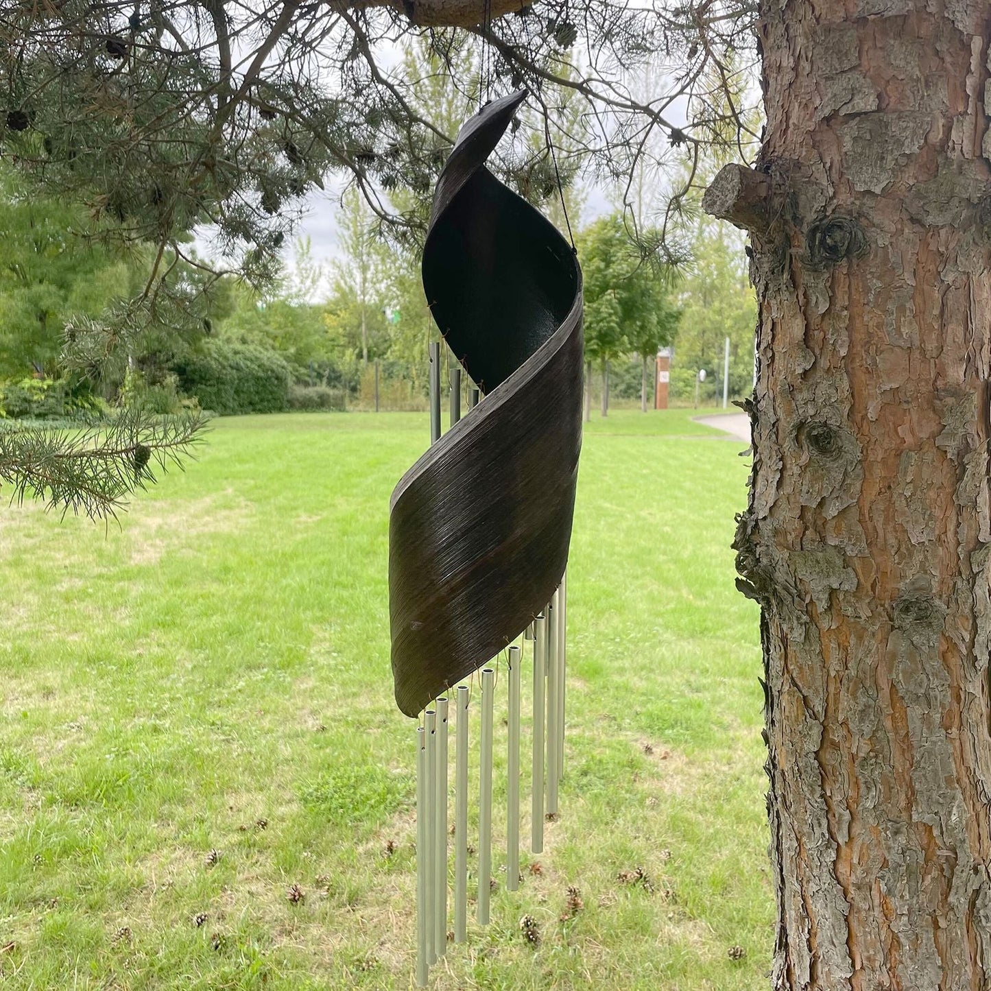 Alt Tag: Chocolate Coconut Leaf Wind Chimes – 50x13 CM hanging outdoors, handcrafted Bali coconut leaf with metal chime tubes