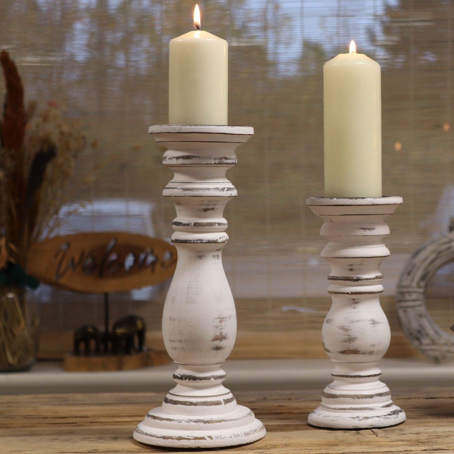 Alt Tag: Classic Candle Stand – Whitewash (23 × 10 CM, Small) small distressed white candle holder with pillar candle on rustic wooden table