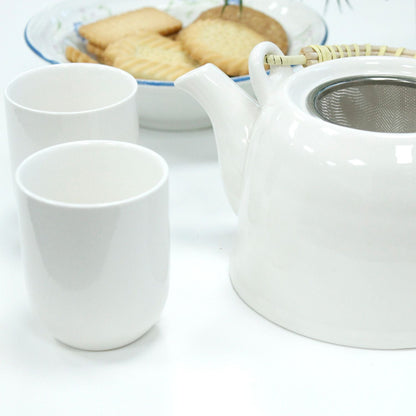 Alt Tag: Classic White Herbal Teapot Set – 850ML, 6 Cups white ceramic teapot with metal infuser and two cups on table