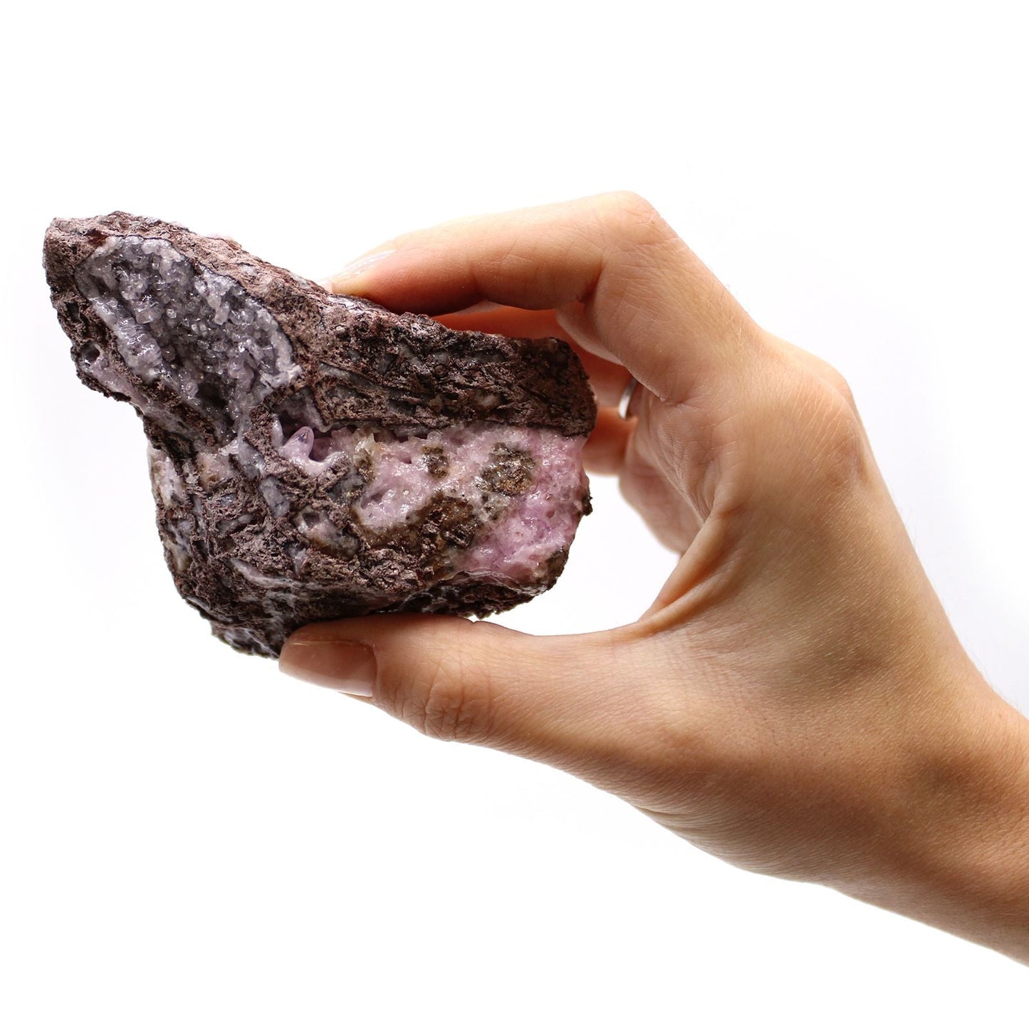 Alt Tag: Cobalt Calcite Mineral Specimens – 25 Pieces, specimen de calcita rosa con matriz oscura sostenido en mano, primer plano