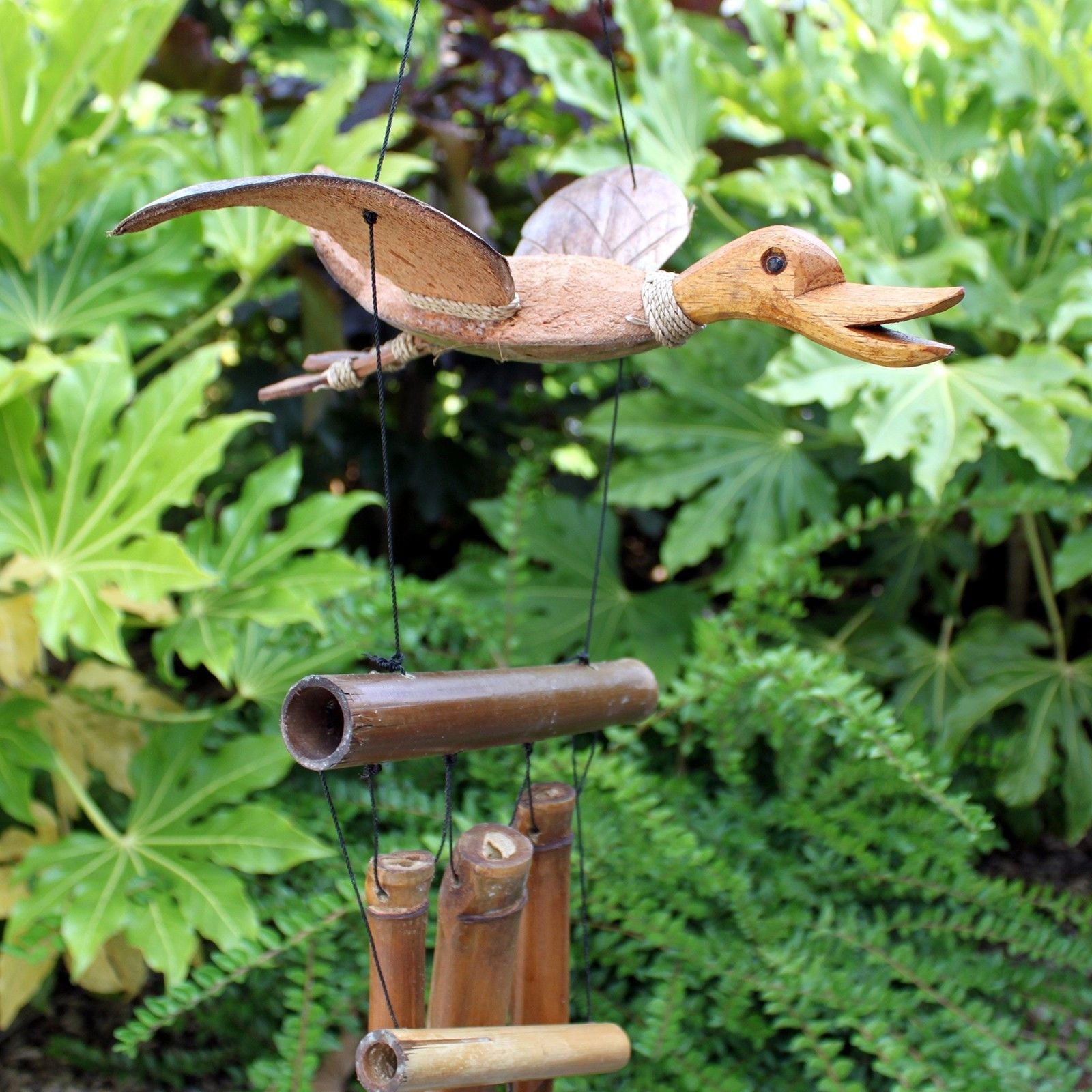 Alt Tag: Coconut Bamboo Wind Chime – 100 CM duck-shaped coconut and bamboo wind chime hanging outdoors with bamboo tubes