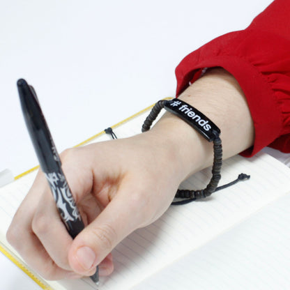 Alt Tag: Coconut Wood Friends Bracelet – Adjustable on wrist, black beaded bracelet with "friends" tag, adjustable cord closure