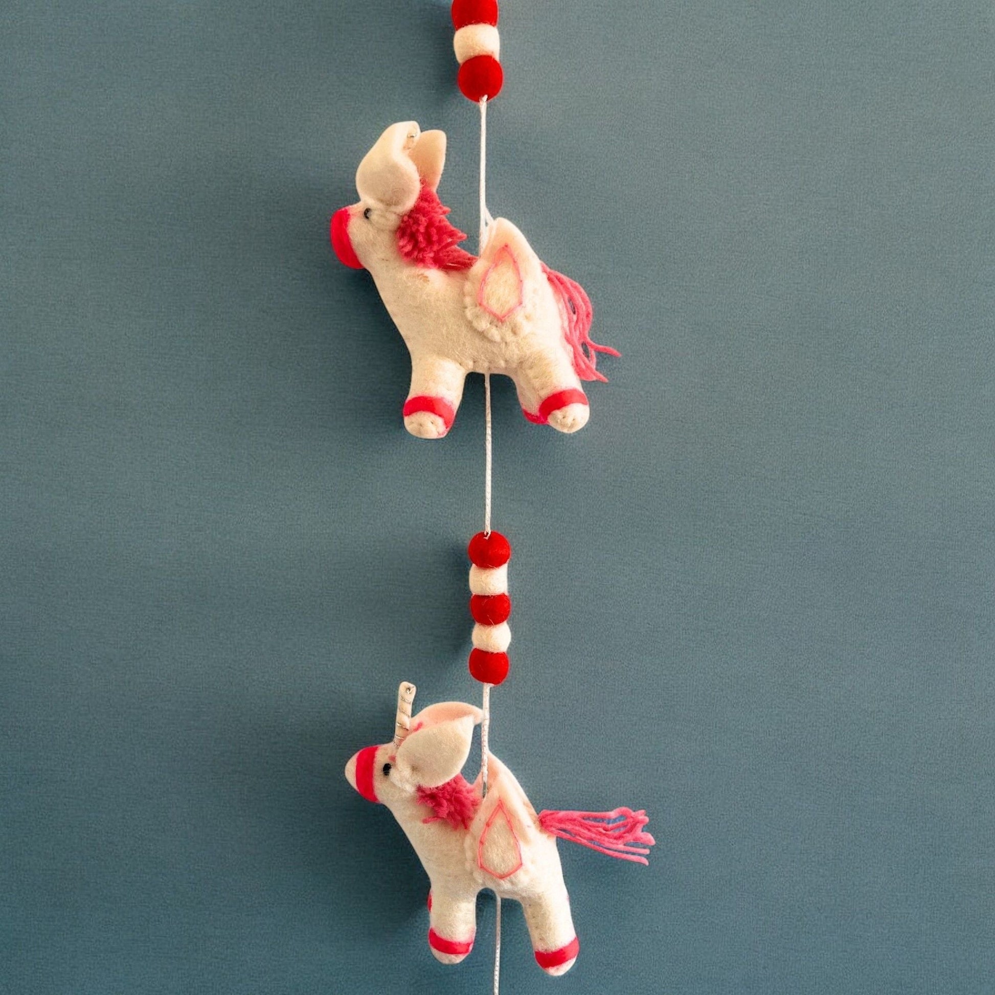 Alt Tag: Colorful Felt Unicorn Wall Hanging – 110CM with handmade felt unicorns and red pom-pom beads, 110 cm hanging decor