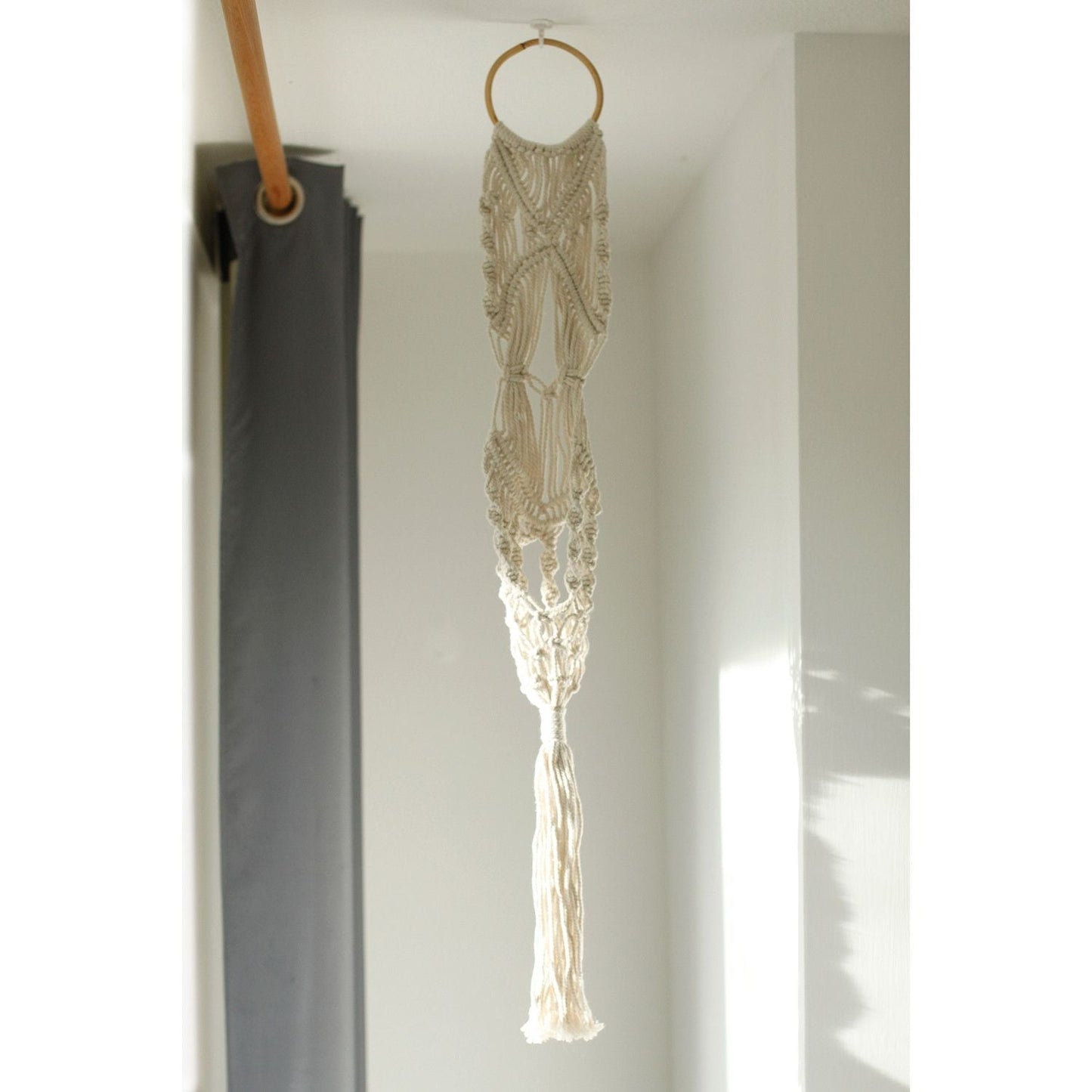 Alt Tag: Cotton Macrame Pot Holder – Long Rattan Hoop 100 CM hanging cotton macrame plant holder with rattan hoop in bright room