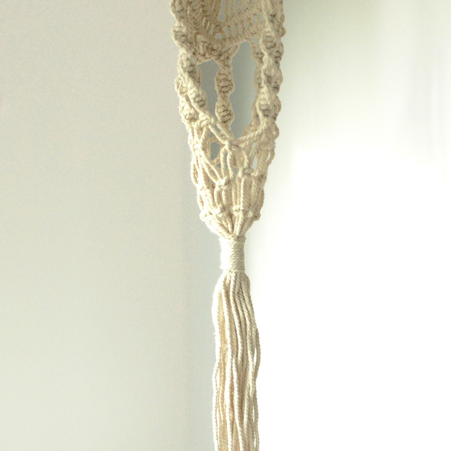 Alt Tag: Cotton Macrame Pot Holder – Long Rattan Hoop 100 CM natural cotton macrame plant hanger close-up with knotted tassel