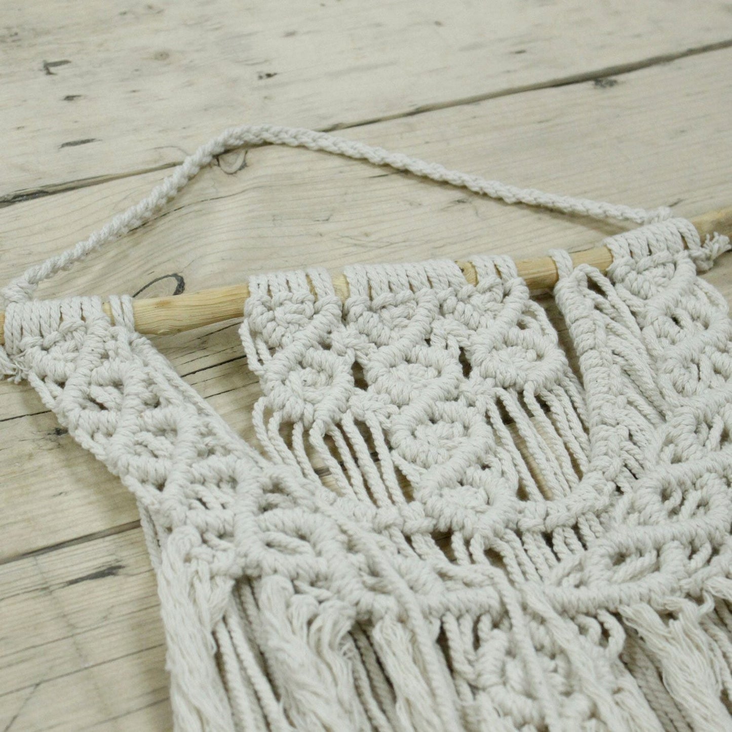 Cotton Macrame Wall Hanging – Wedding Blessing close-up of cotton knotted macrame wall decor with tassels on wooden dowel, boho style