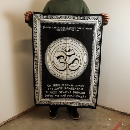 Alt Tag: Cotton Om Wall Art – 70x110 CM black cotton wall hanging with Om symbol and decorative border, shown held up for size