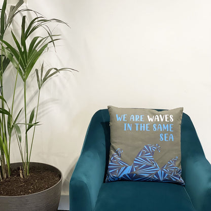 Cotton Poem Cushion Cover – We Are Waves, Natural – 45x45 CM on teal armchair, natural cotton cover with blue wave graphic