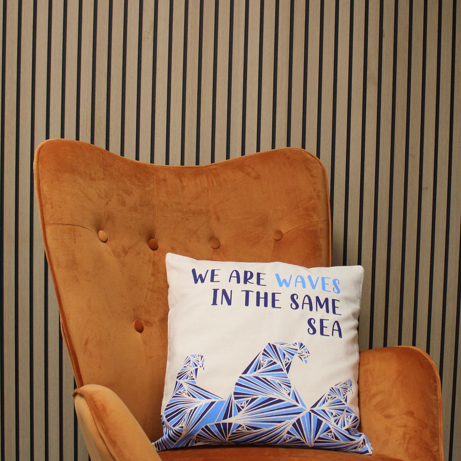 Alt Tag: Cotton Poem Cushion Cover – We Are Waves, Natural – 45x45 CM on armchair, white cotton cover with “We are waves” quote