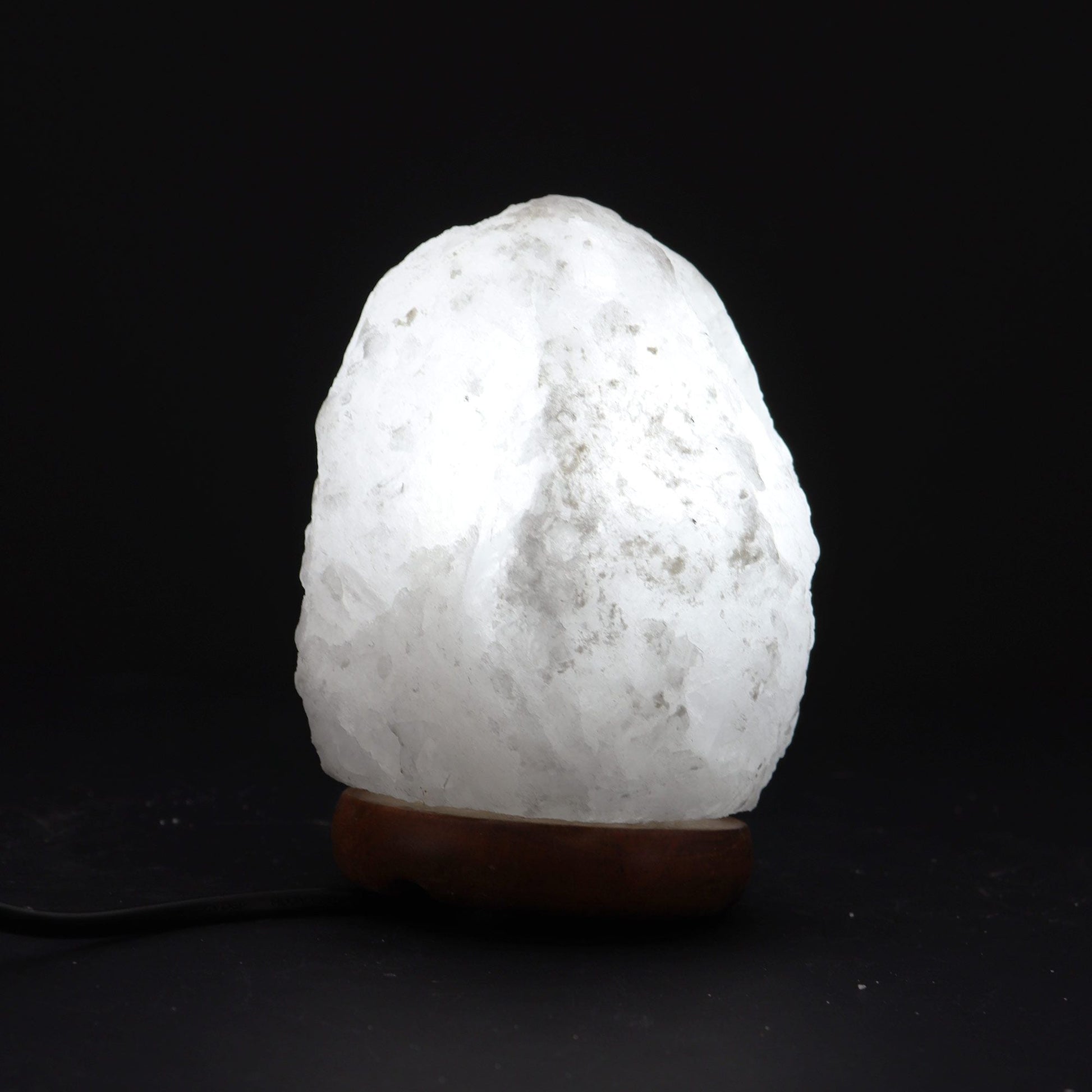 Alt Tag: Crystal Rock Himalayan Salt Lamp – Approx. 1.5–2 KG white crystal rock salt lamp on wooden base, soft ambient glow
