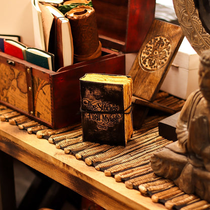 Deckled Edge Leather Notebook – 9x13 CM - The Stories I Tell Myself on wooden desk with rustic decor and journals