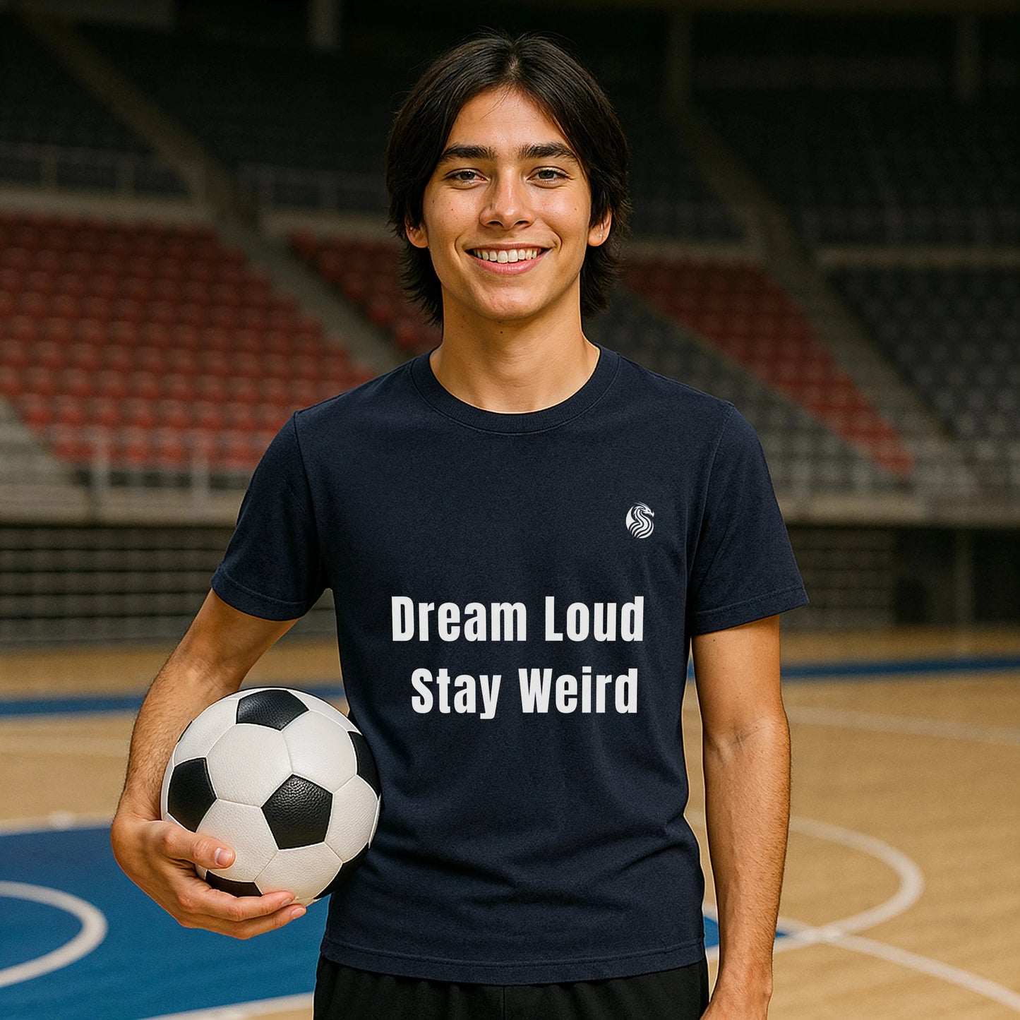 Alt Tag: Dream Loud. Stay Weird % Drix Sustainable Unisex Tee worn by smiling person holding soccer ball on indoor court