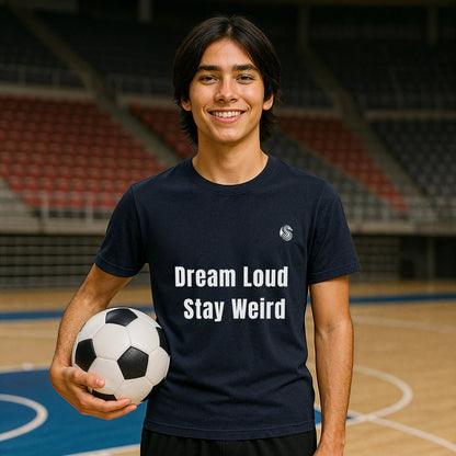Alt Tag: Dream Loud. Stay Weird % Drix Sustainable Unisex Tee worn by smiling person holding soccer ball on indoor court