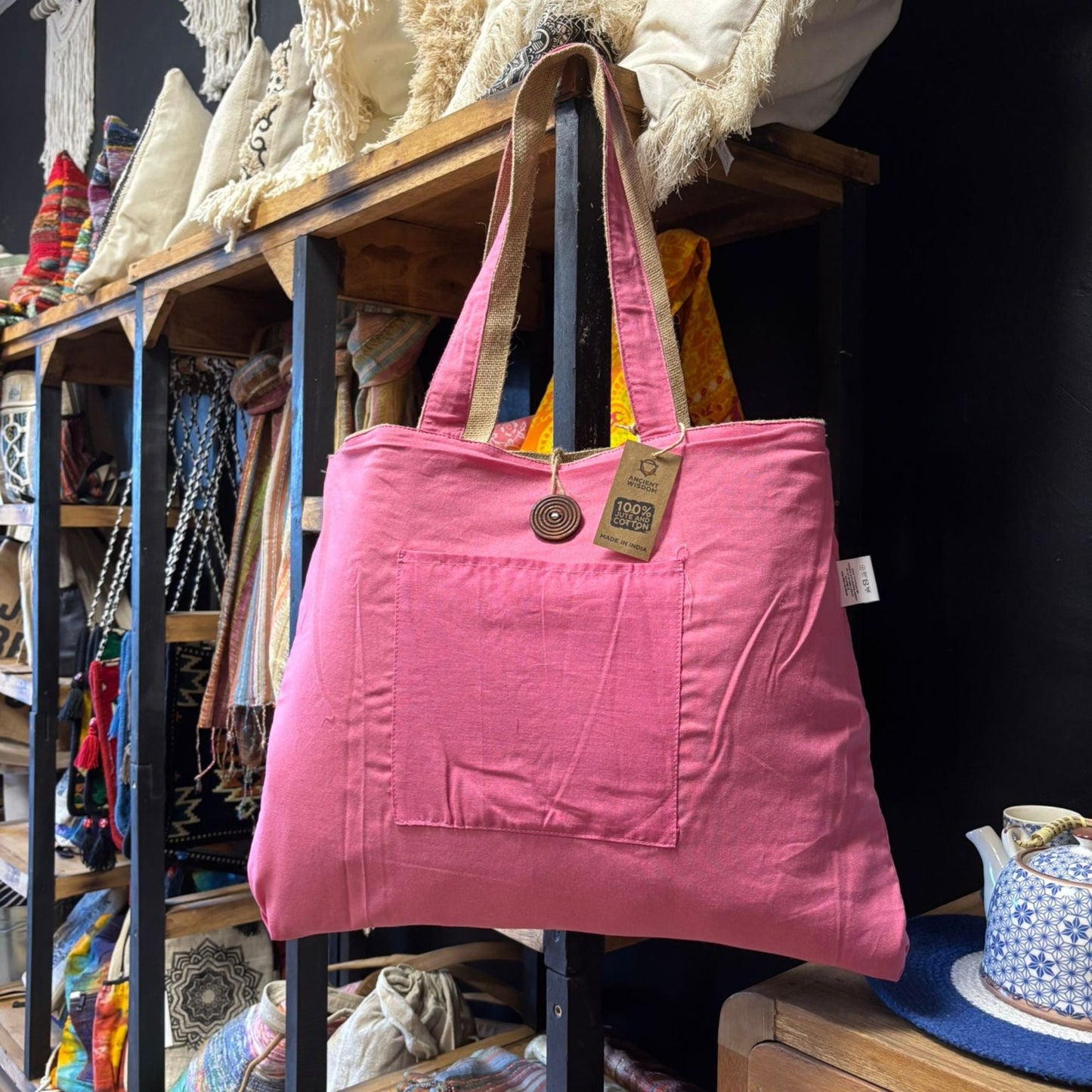 Alt Tag: Eco-Chic Reversible Jute & Cotton Bag – Pink pink reversible jute and cotton tote bag hanging, spacious 49x40 cm